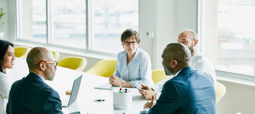 Group of businesspeople in team meeting in office conference room
