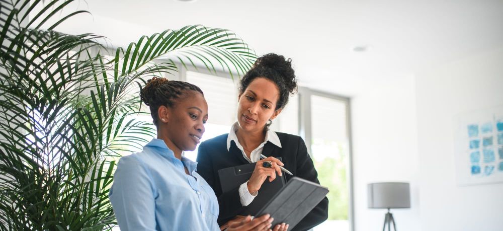 An inclusive leader collaborates with a team member