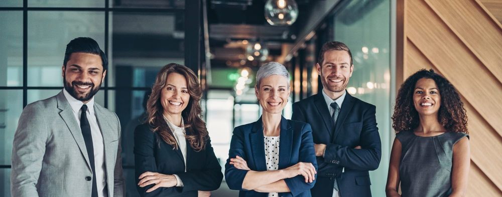 A diverse team in a modern office is ready to become inclusive leaders