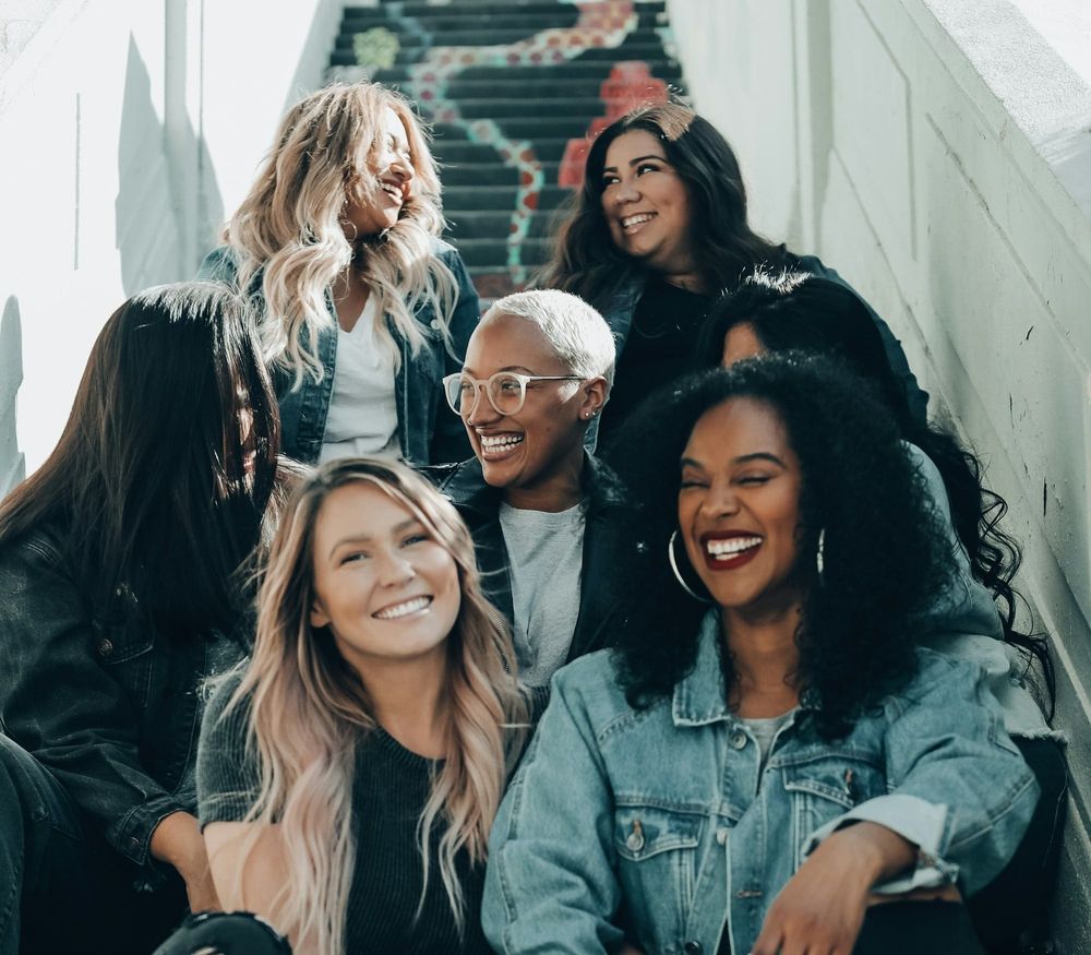 A group of women sitting on a staircase