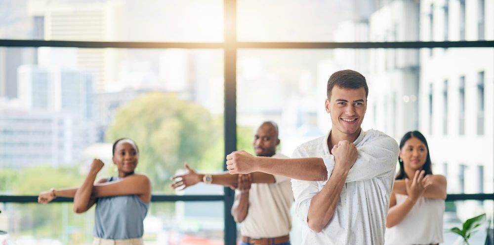 Employees focused on well-being complete a group exercise