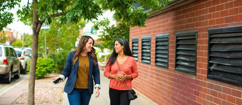 Two colleagues take a mental health walk