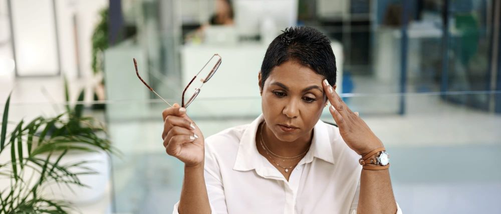 An employee looks anxious about AI on her laptop
