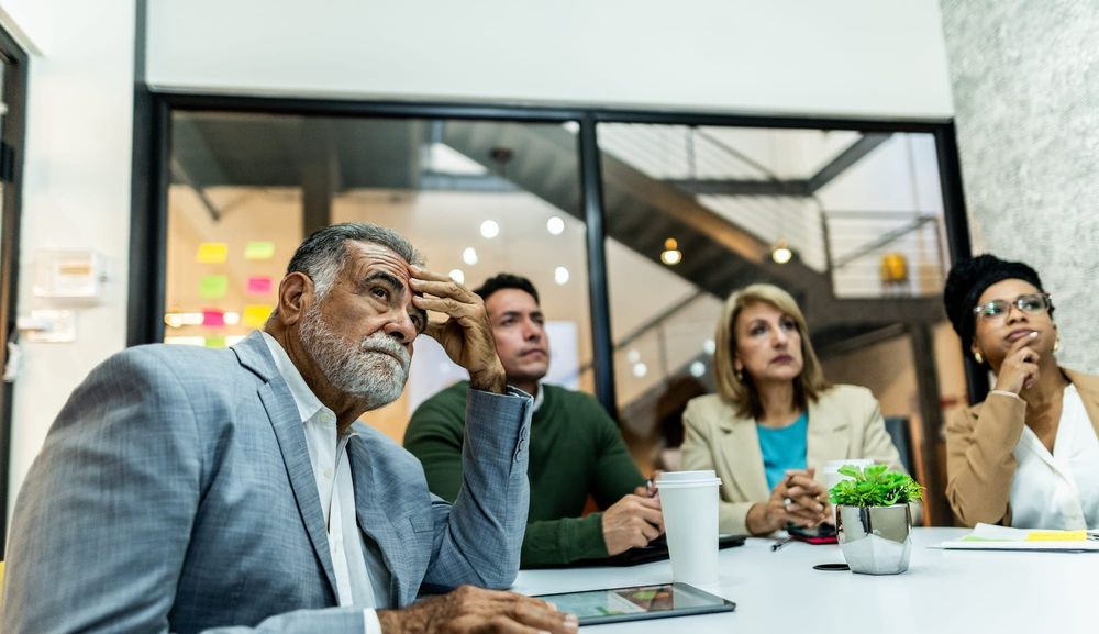 A seasoned employee anxiously attends a meeting