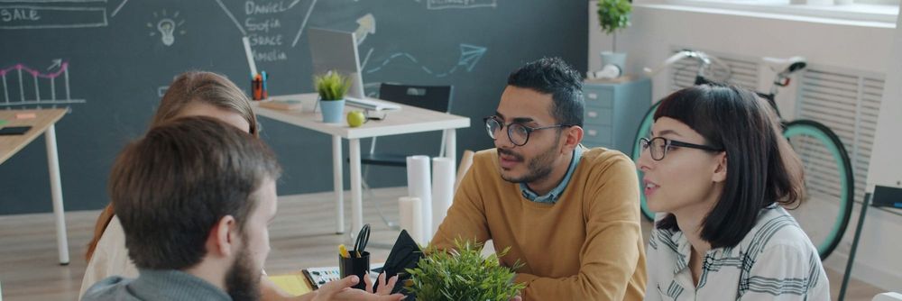 A team of four discuss their communication strategies