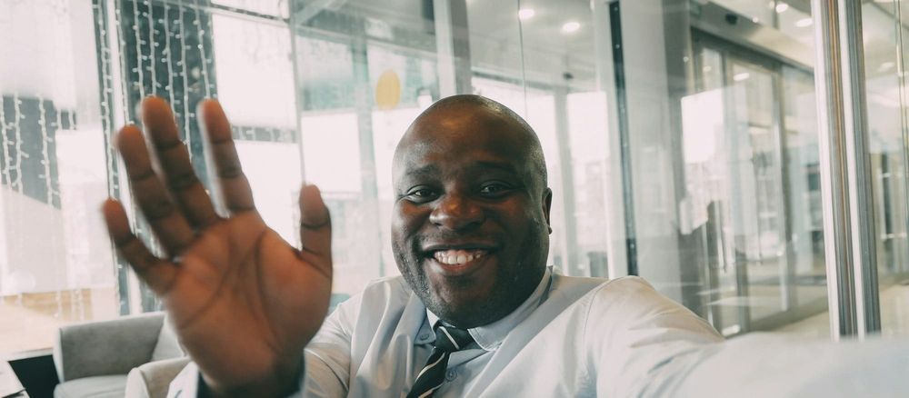 Employee waves on video call