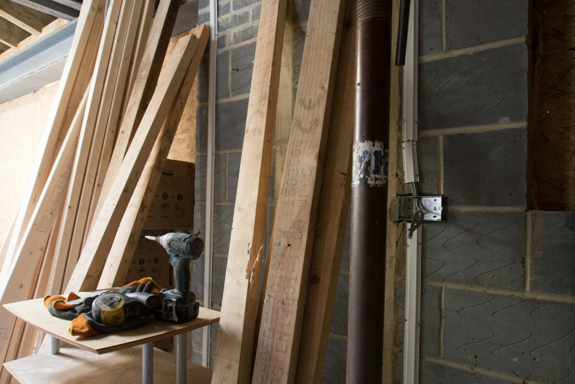 brown wooden ladder leaning on wall