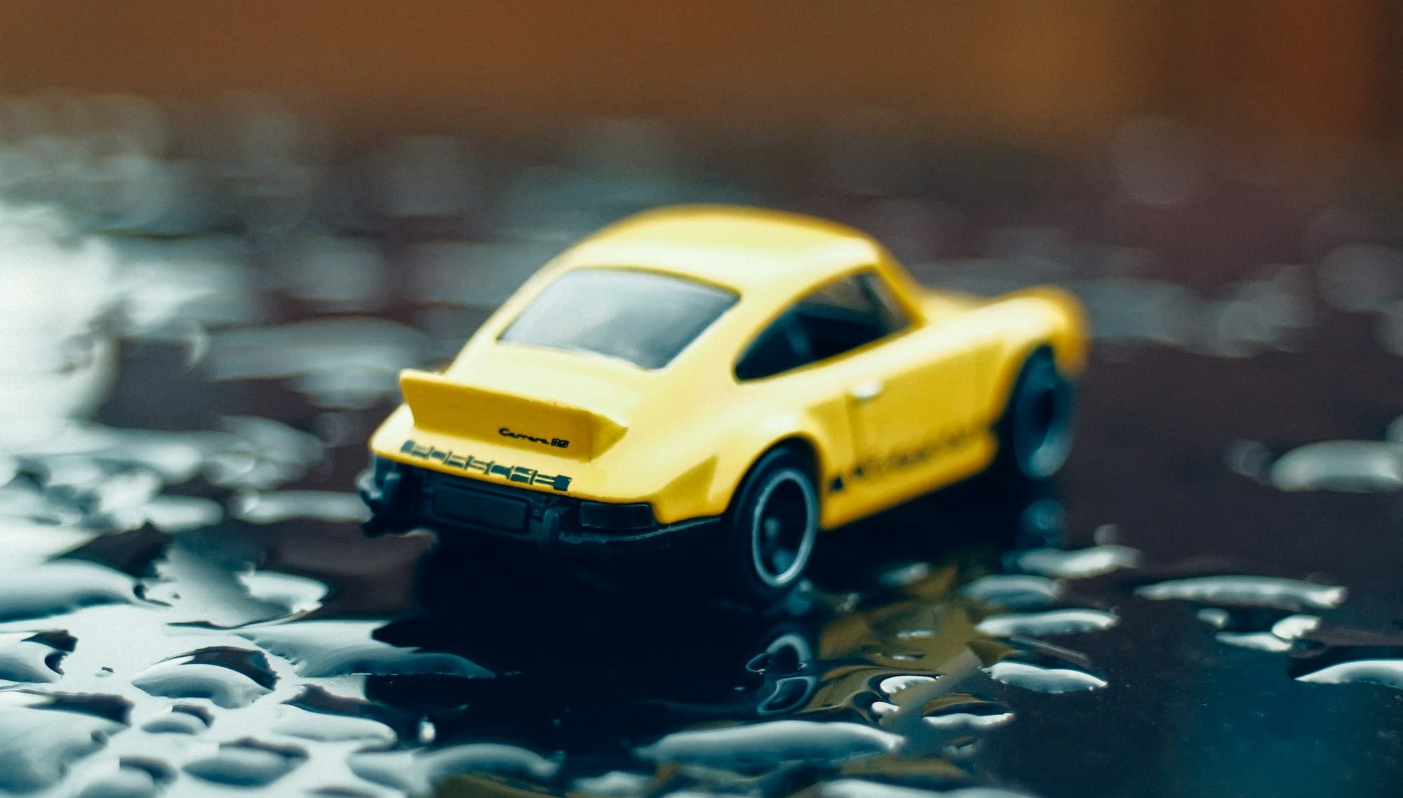 a yellow toy car sitting on top of a table