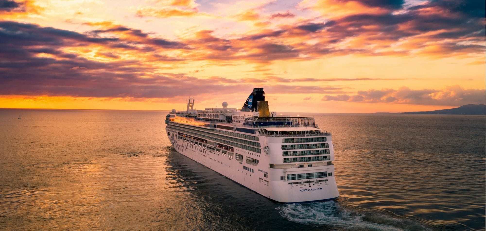 white cruise ship under cloudy sky