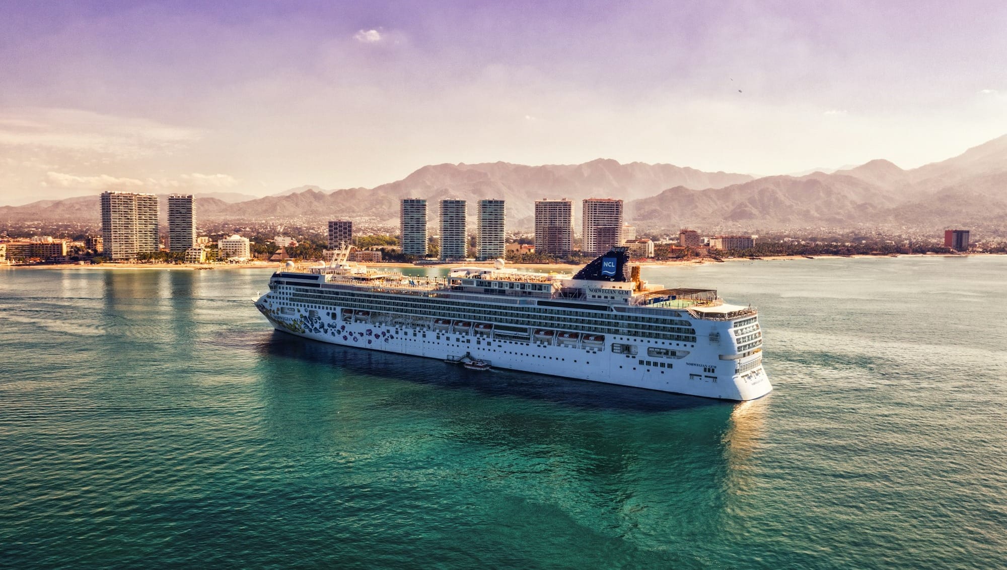 white and blue boat on body of water during daytime