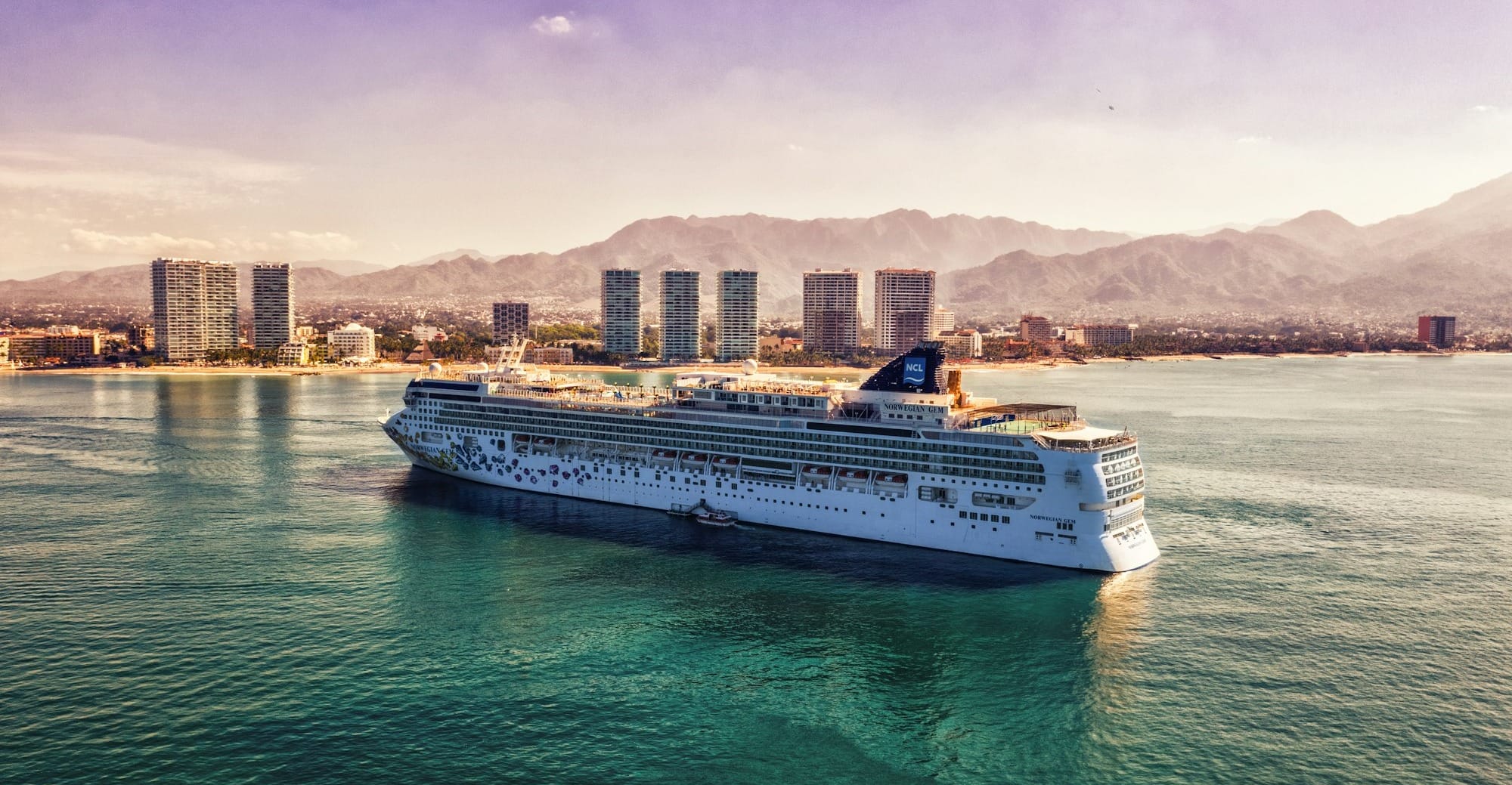 white and blue boat on body of water during daytime