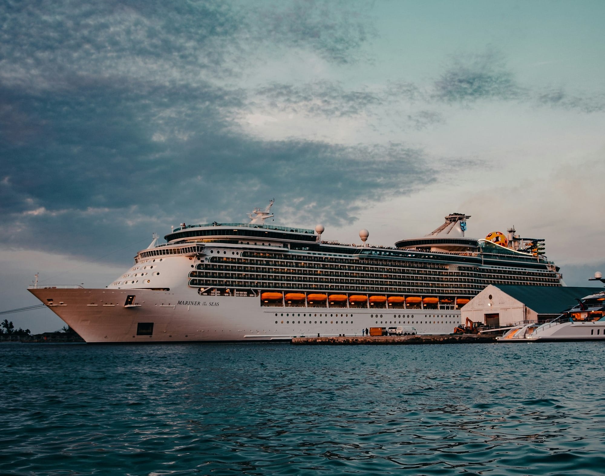 white cruise ship on sea under white clouds and blue sky during daytime
