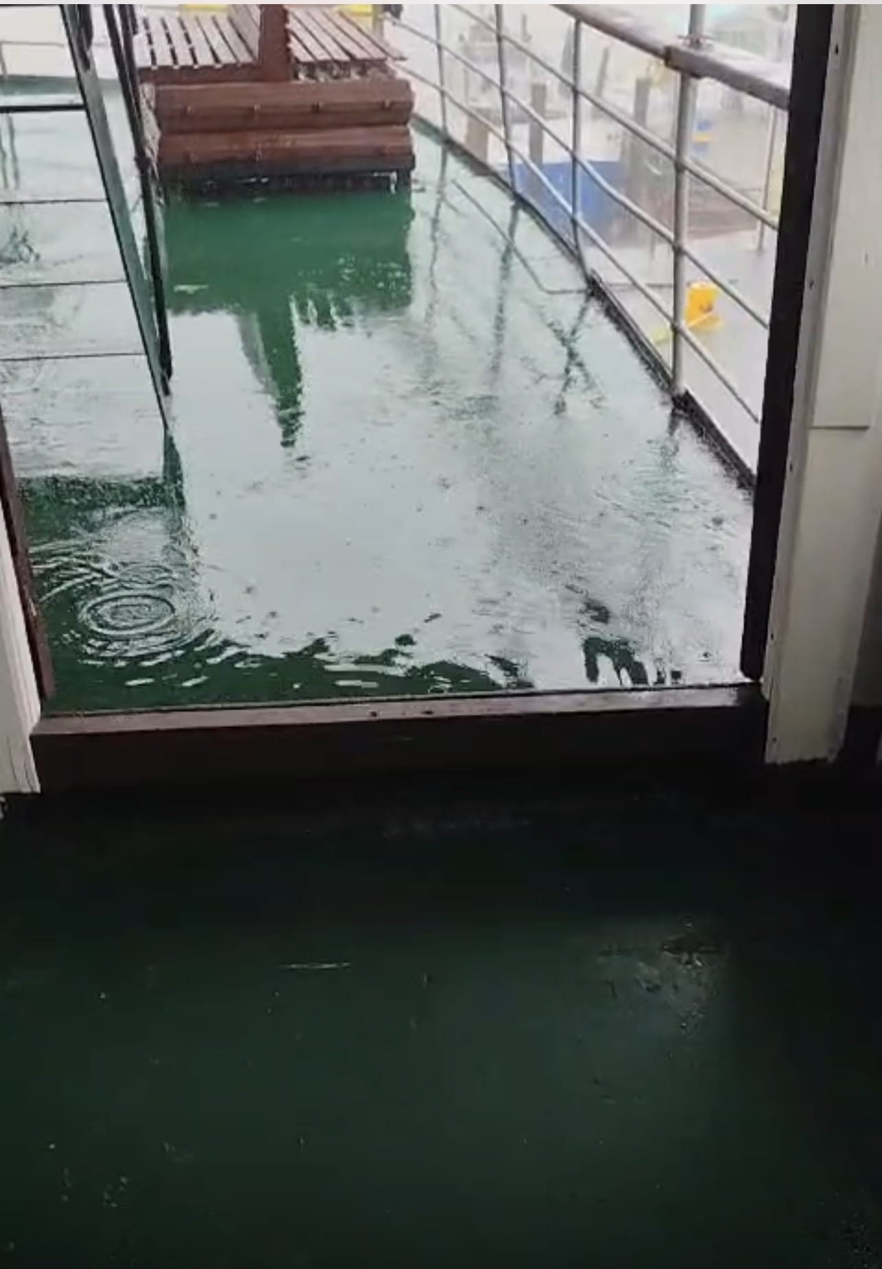 The vessel alongside at Bartica in heavy rain. Water stood on the open deck and did not clear.