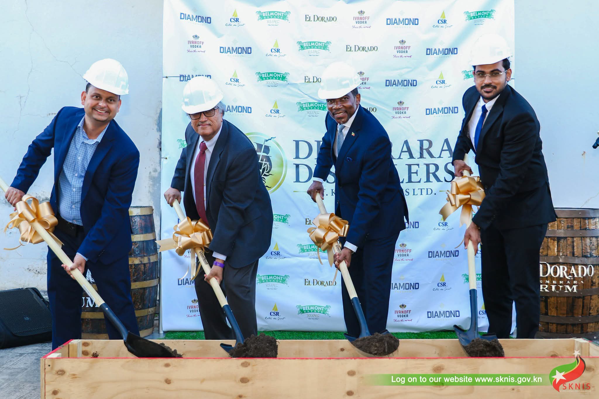 The sod-turning for Demerara Distillers (St Kitts and Nevis) Limited's Bird Rock redevelopment, 6 August 2026. The backdrop carries the group's brand portfolio: El Dorado, Diamond Reserve, Belmont Estate, CSR and Ivanoff.