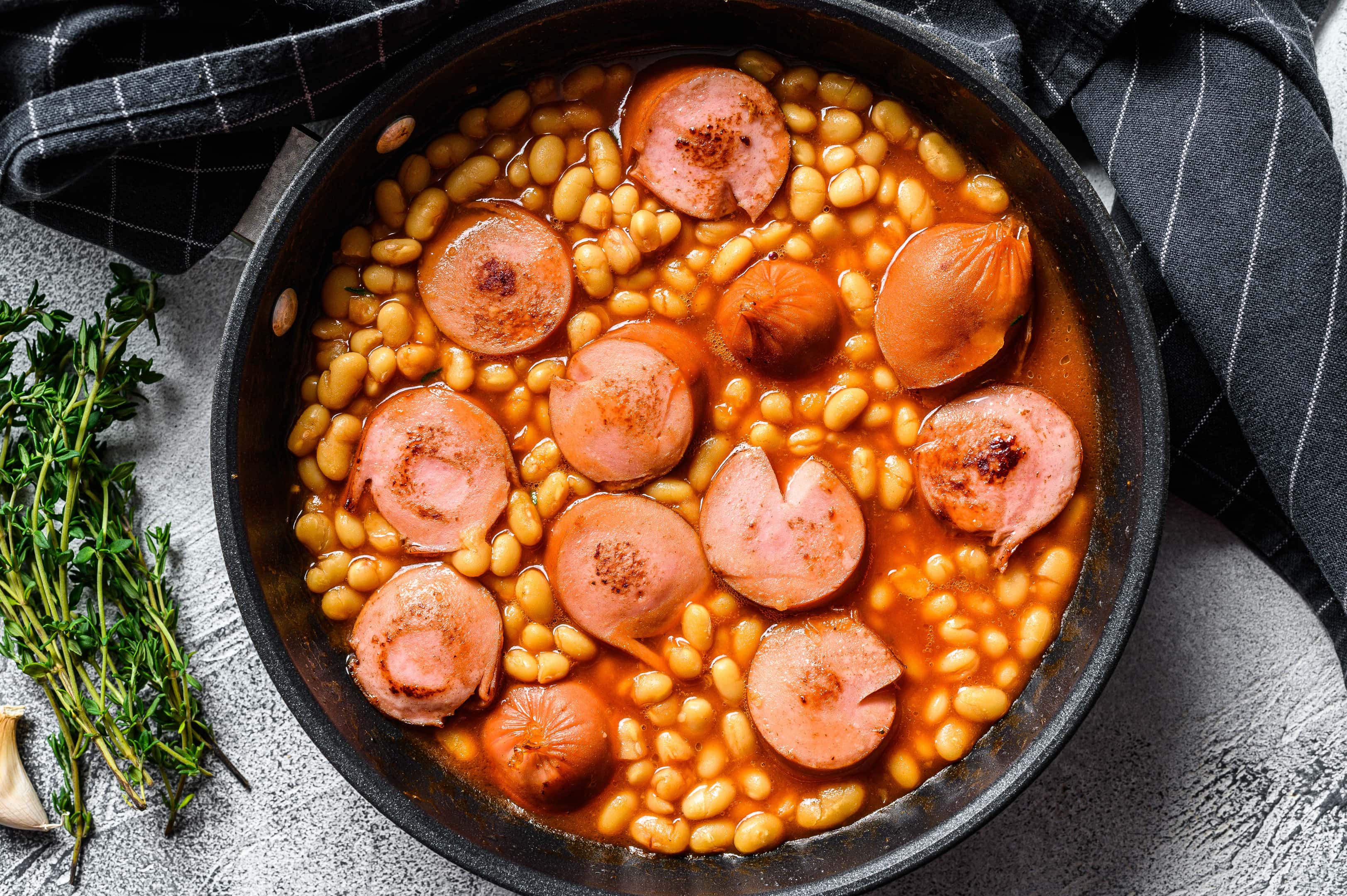 Beans with sausages in tomato sauce