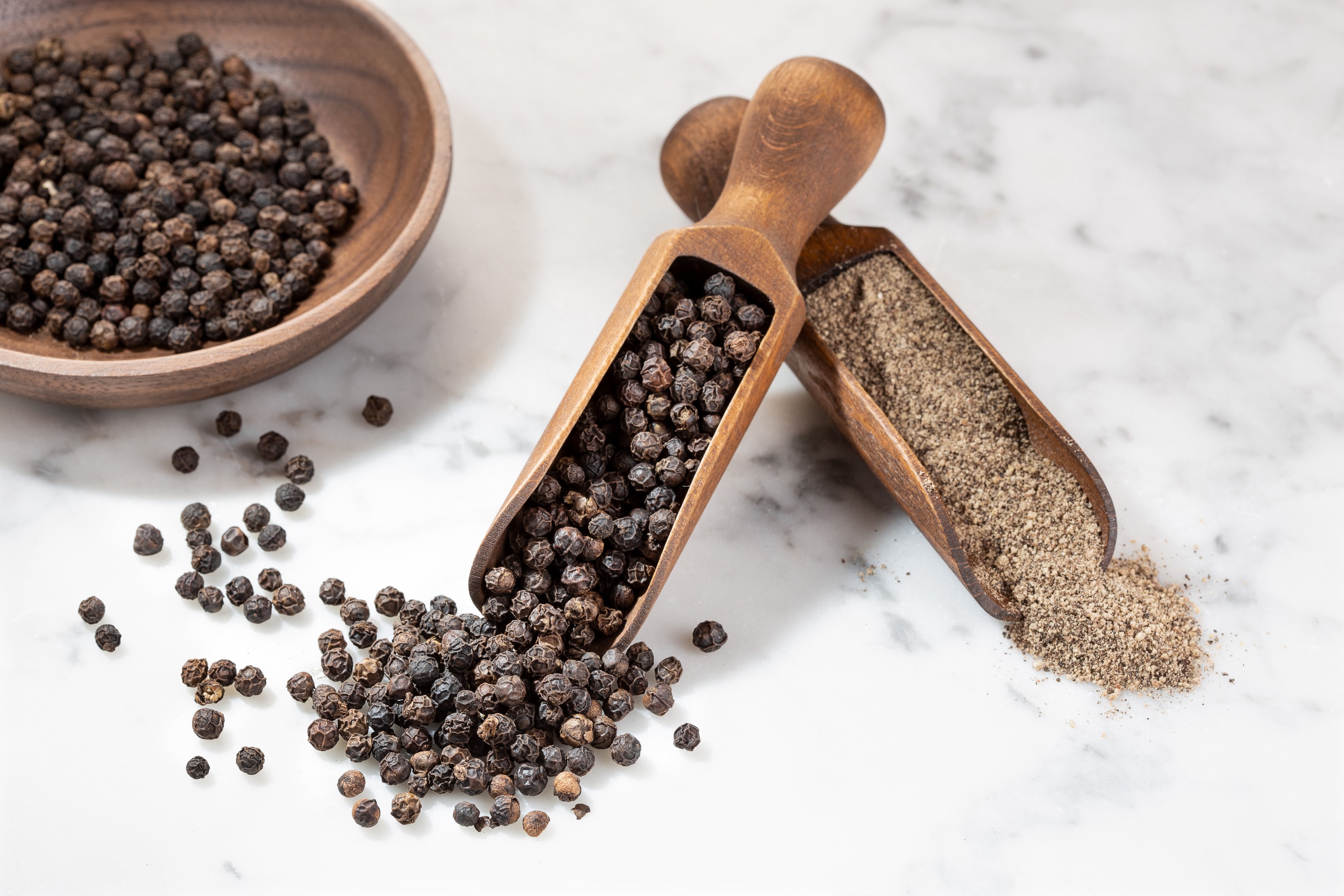Black peppercorns and ground black pepper