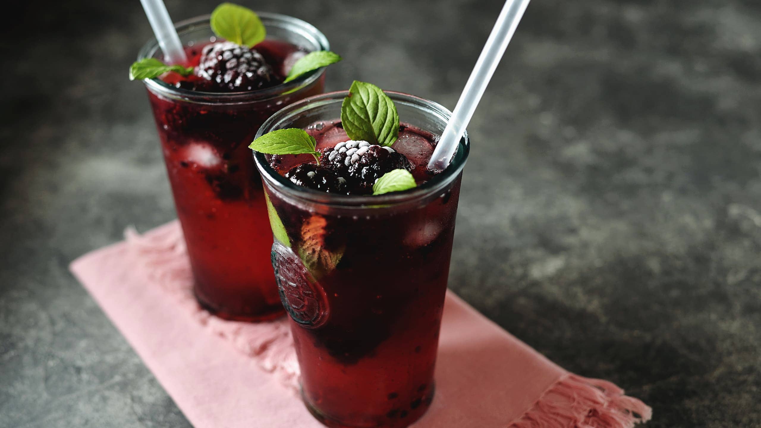Blackberry moonshine with mint, ice, and frozen berries