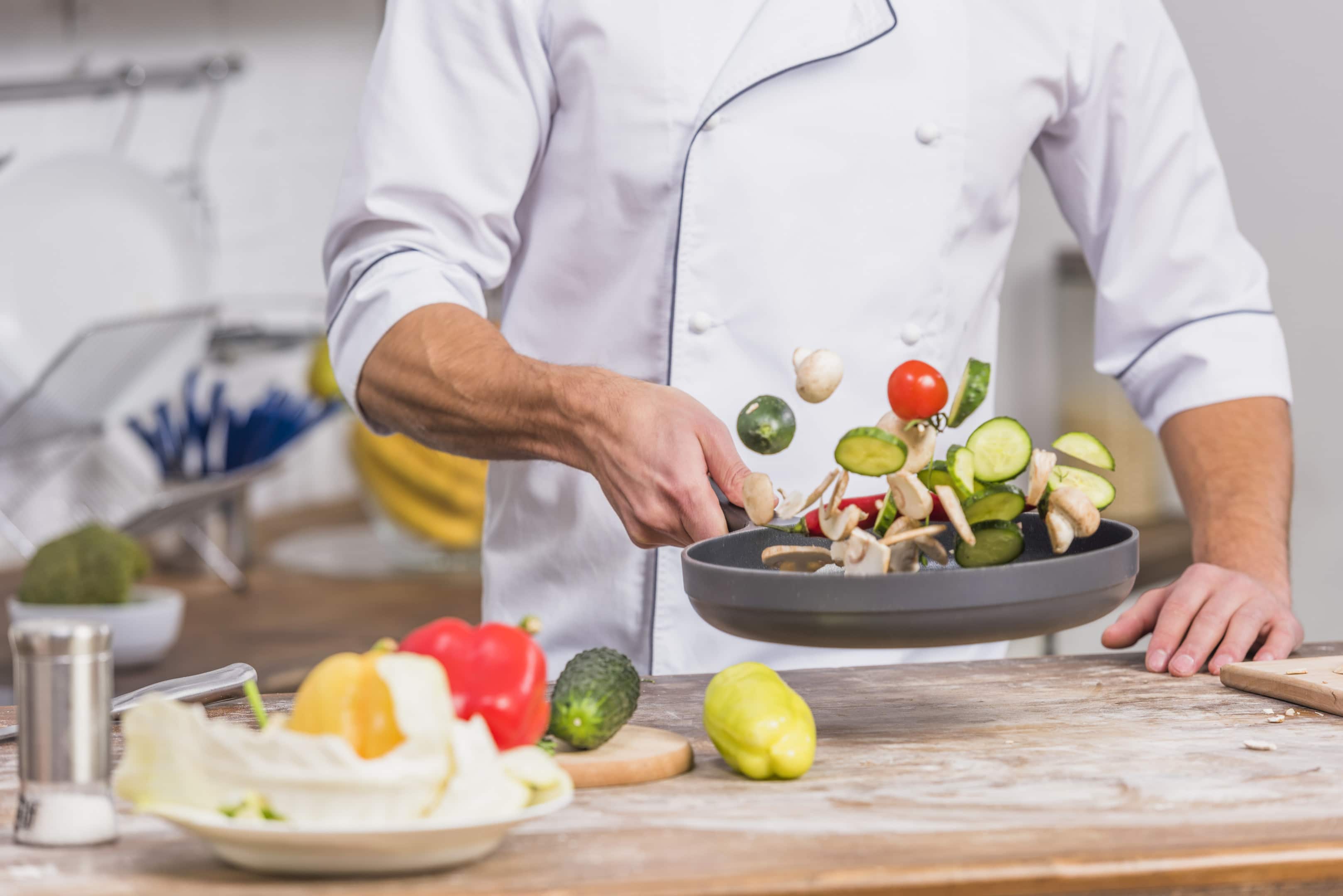A chef cooking fresh vegetables