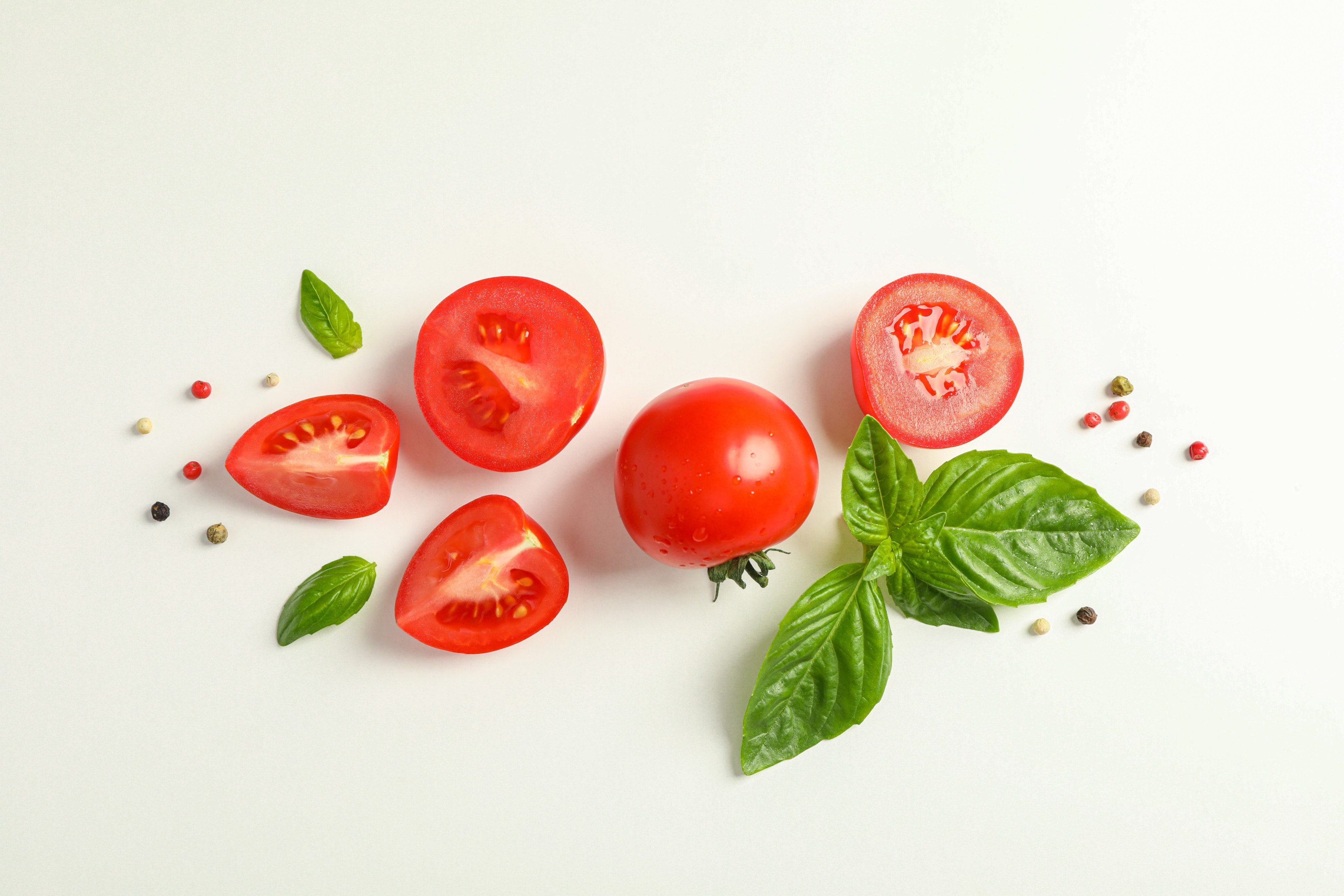 Fresh cherry tomatoes and basil on white background