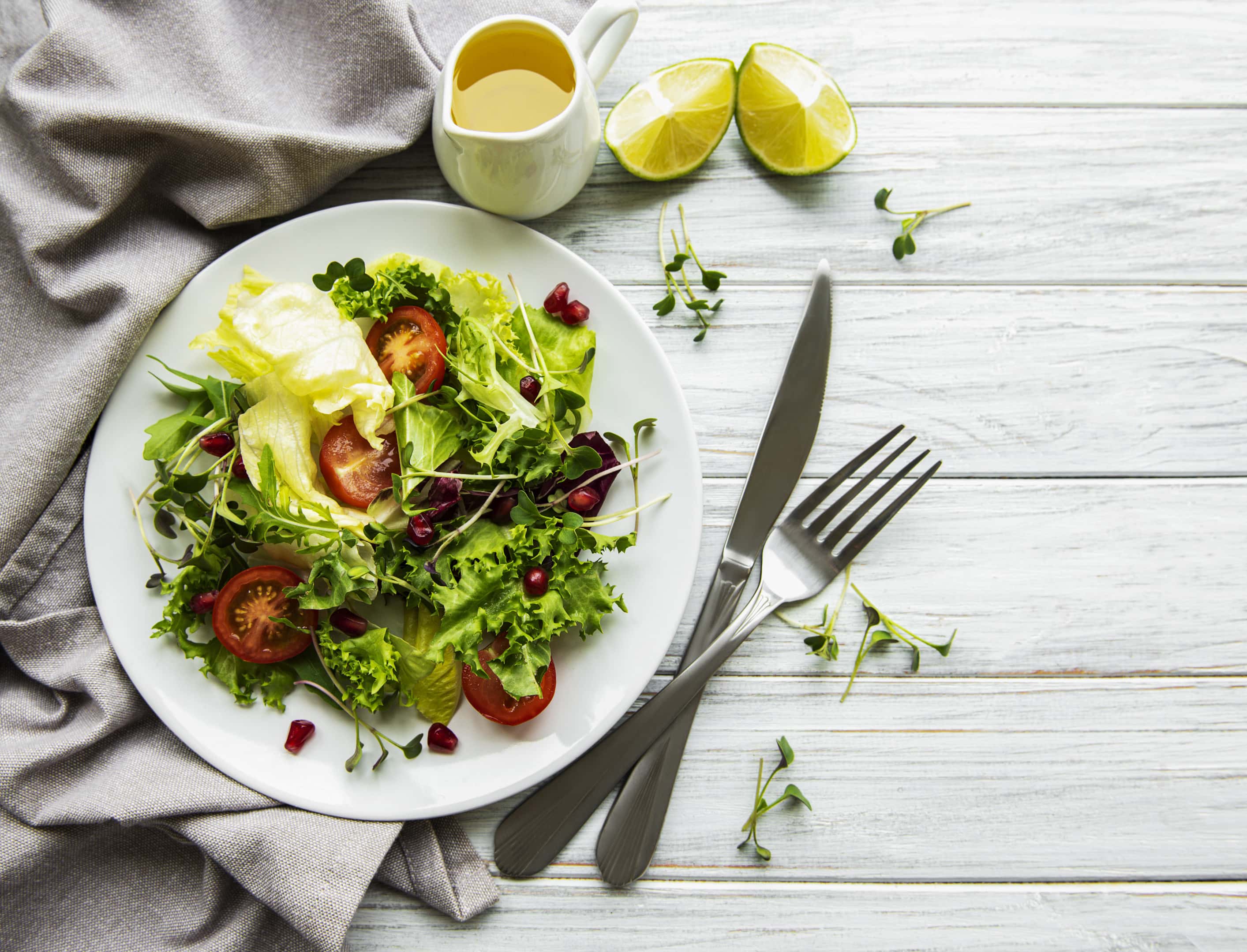 Fresh green mixed salad bowl with tomatoes and broccoli sprouts