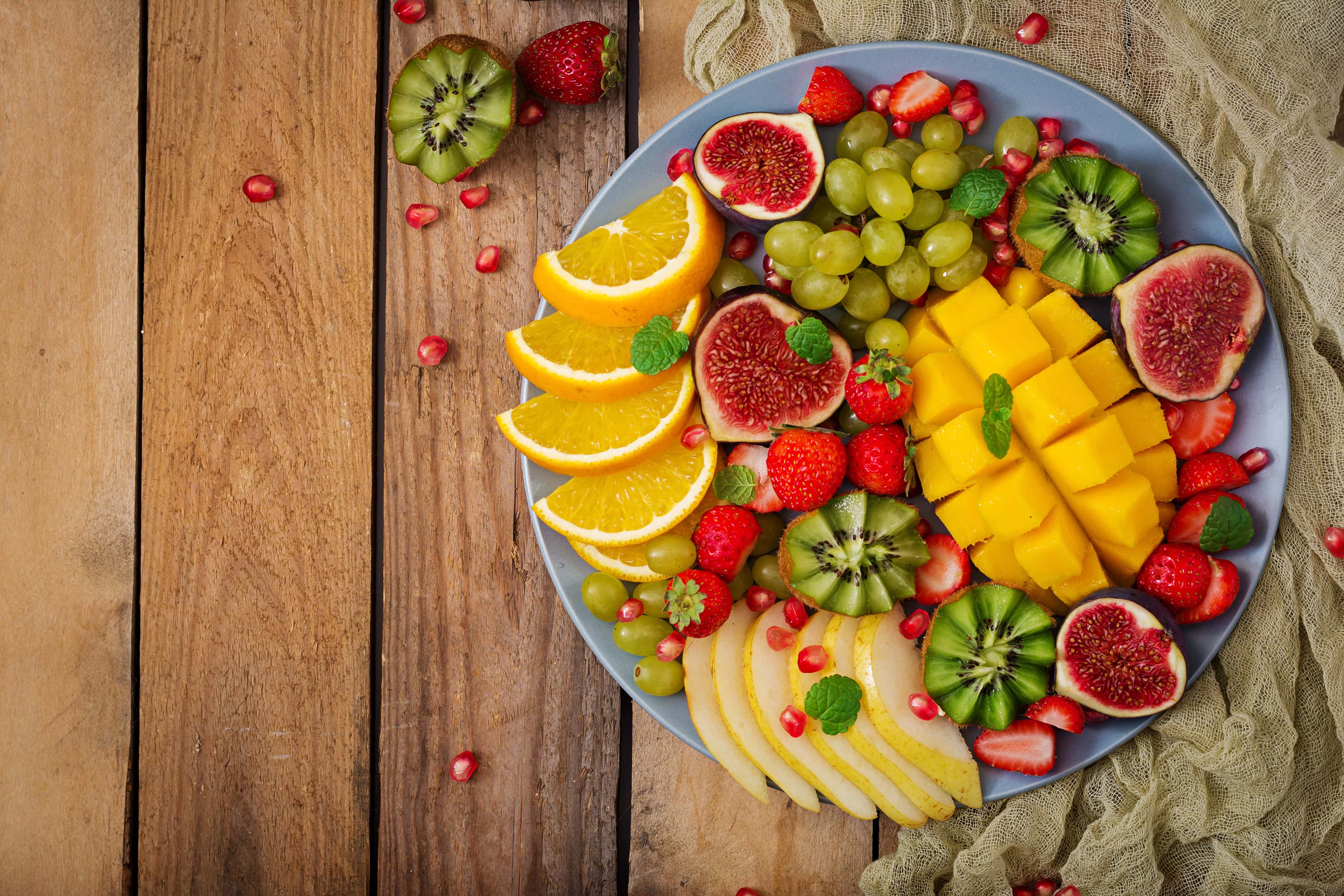 Platter of fruits and berries. Mango, kiwi, fig, strawberry, grapes, pear and orange