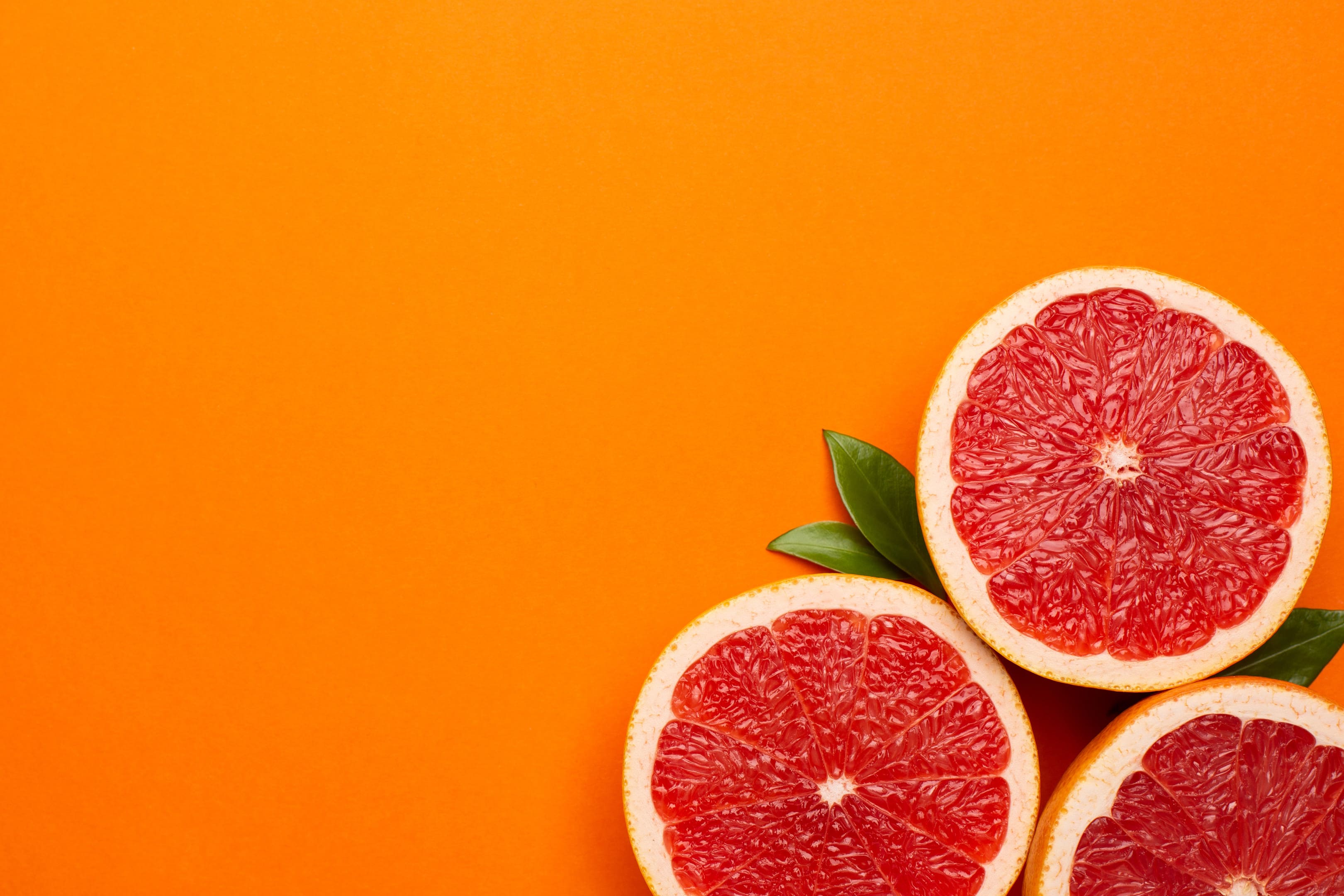 Grapefruit on orange background