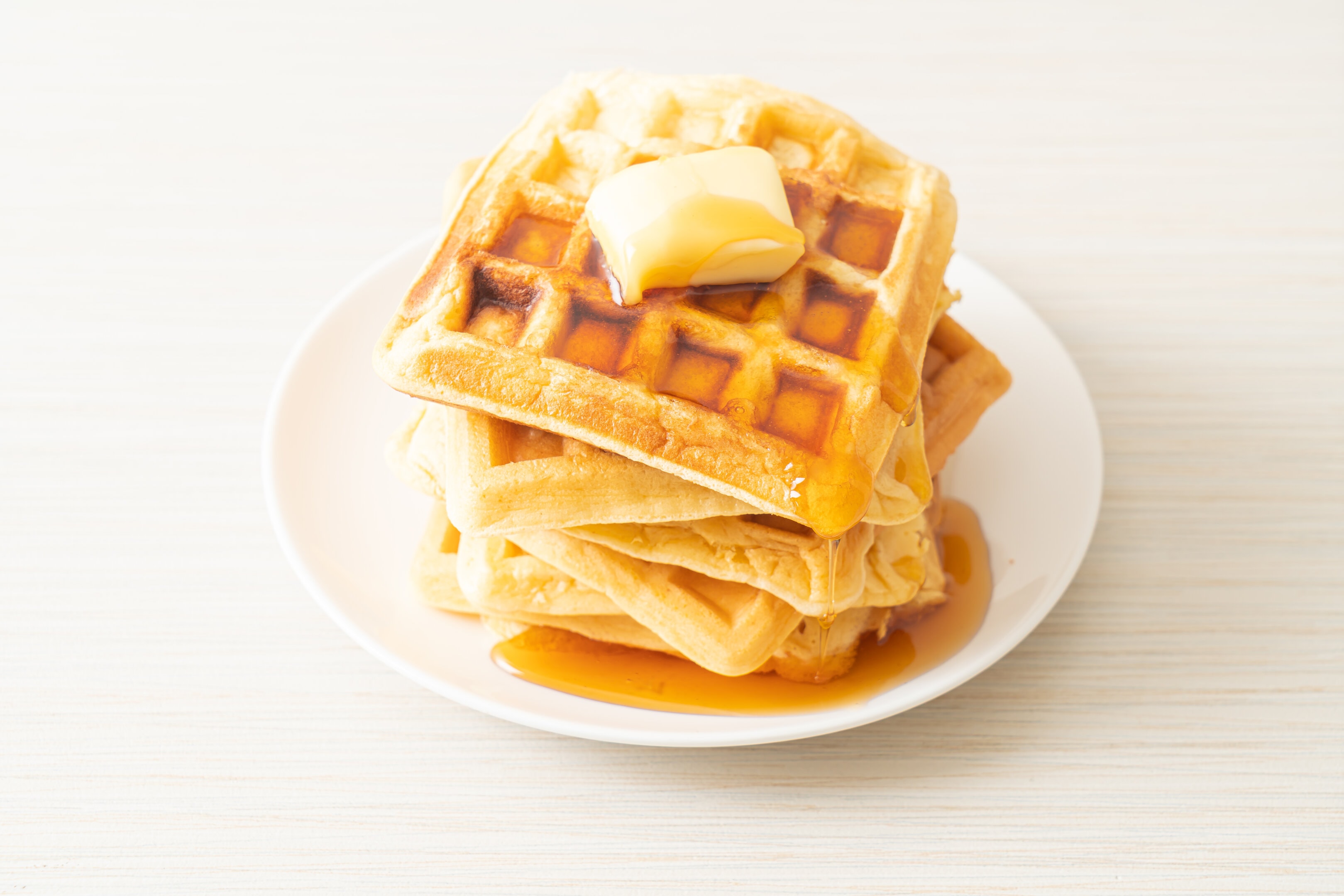 Homemade Aunt Jemima waffle with butter and honey maple syrup