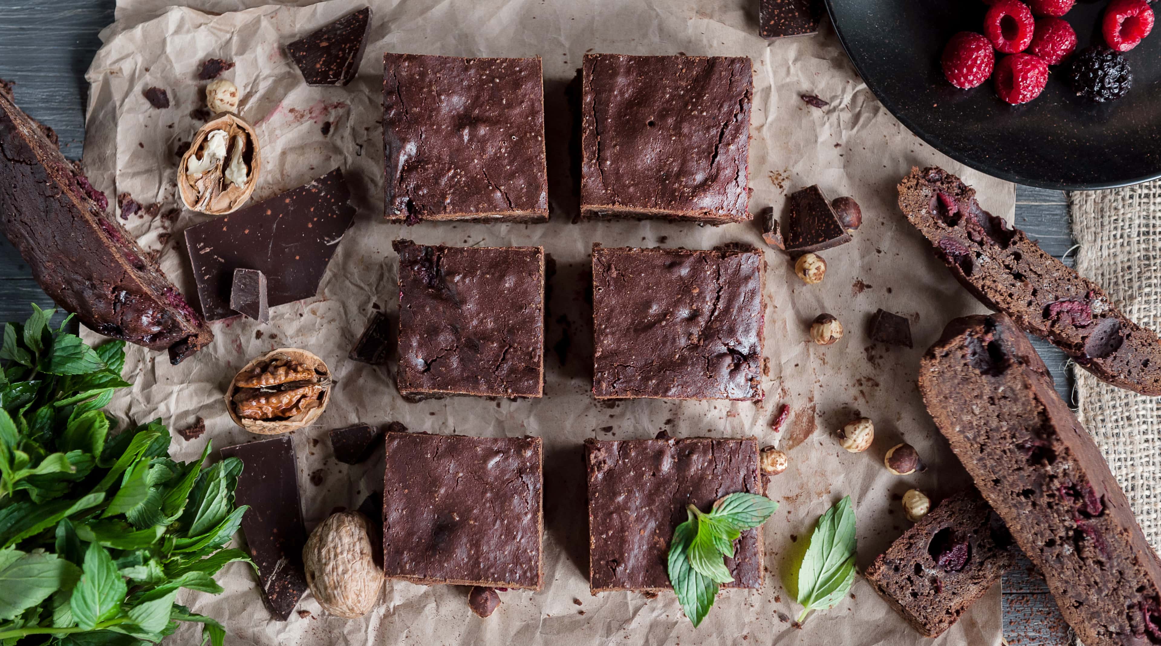 Homemade chocolate chickpea brownie vegan and gluten-free on a paper with nuts