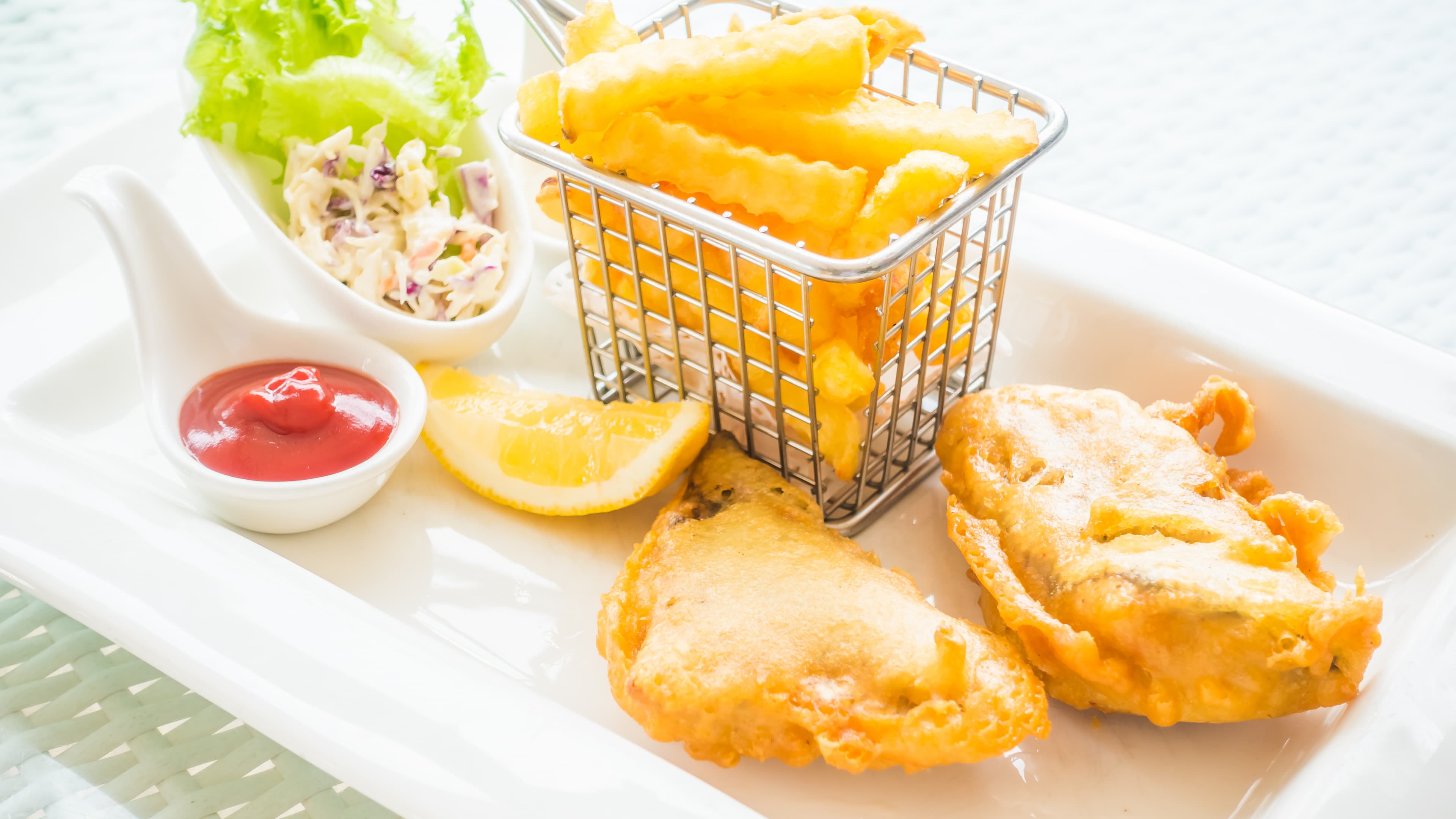 Long John Silver's batter fish with fries, lemon, greens, and dip