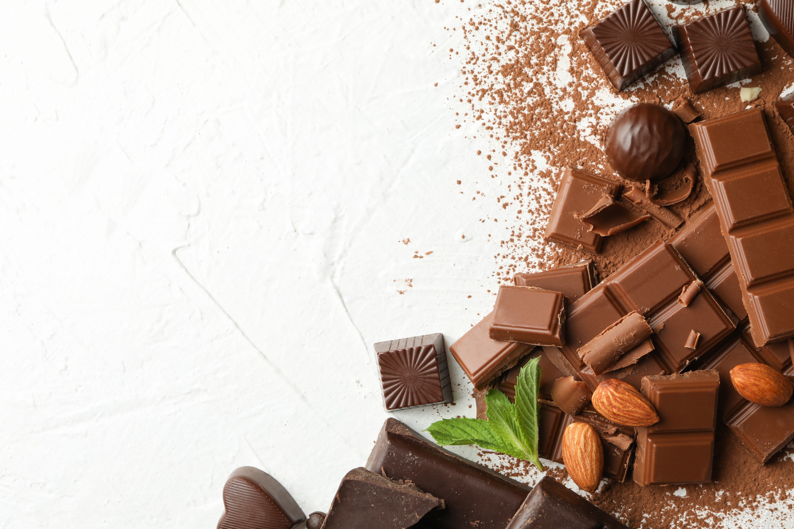 Milk chocolate and dark chocolate with almonds on white background