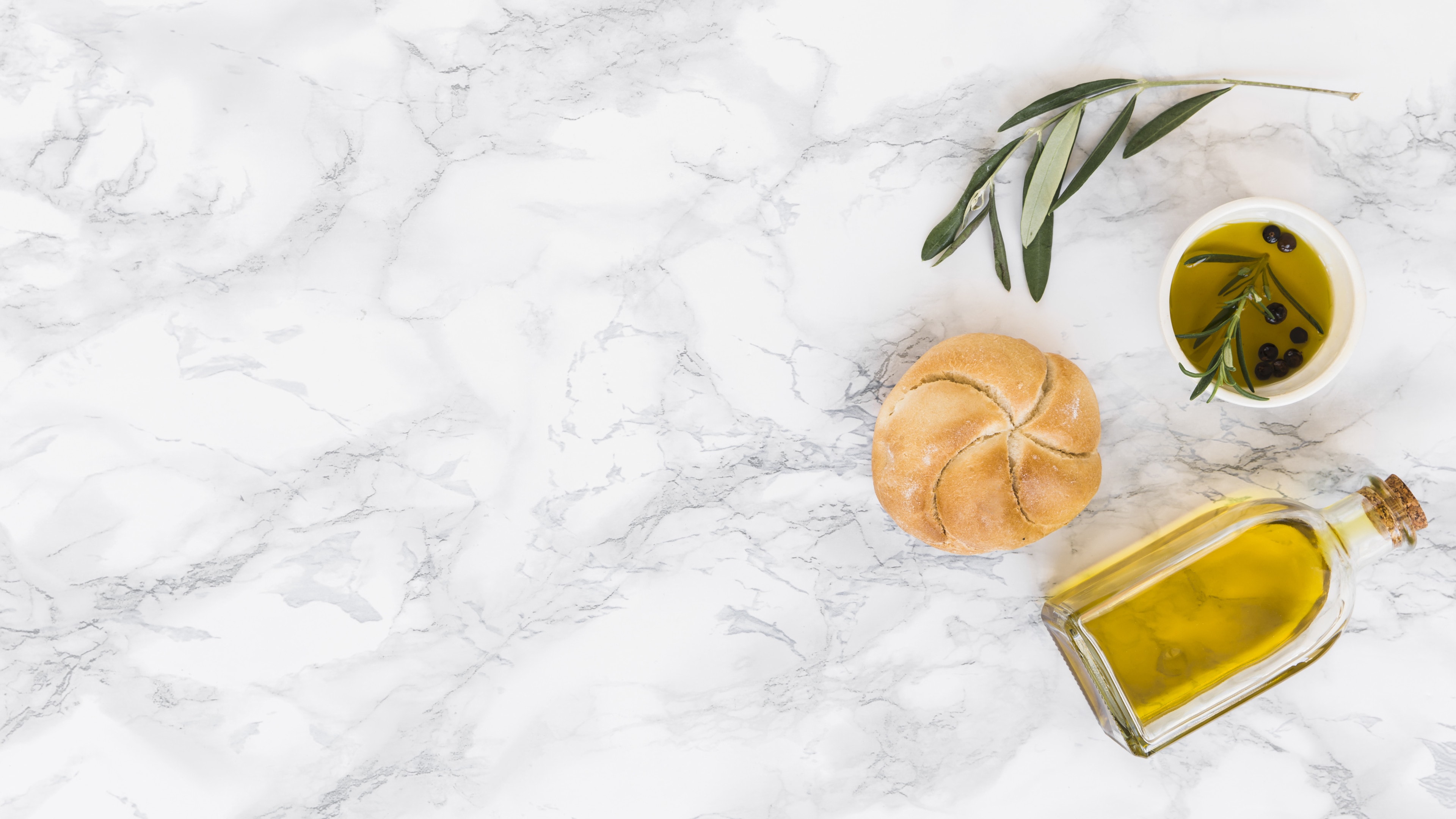 Olive oil bottle with bun baked with olive oil