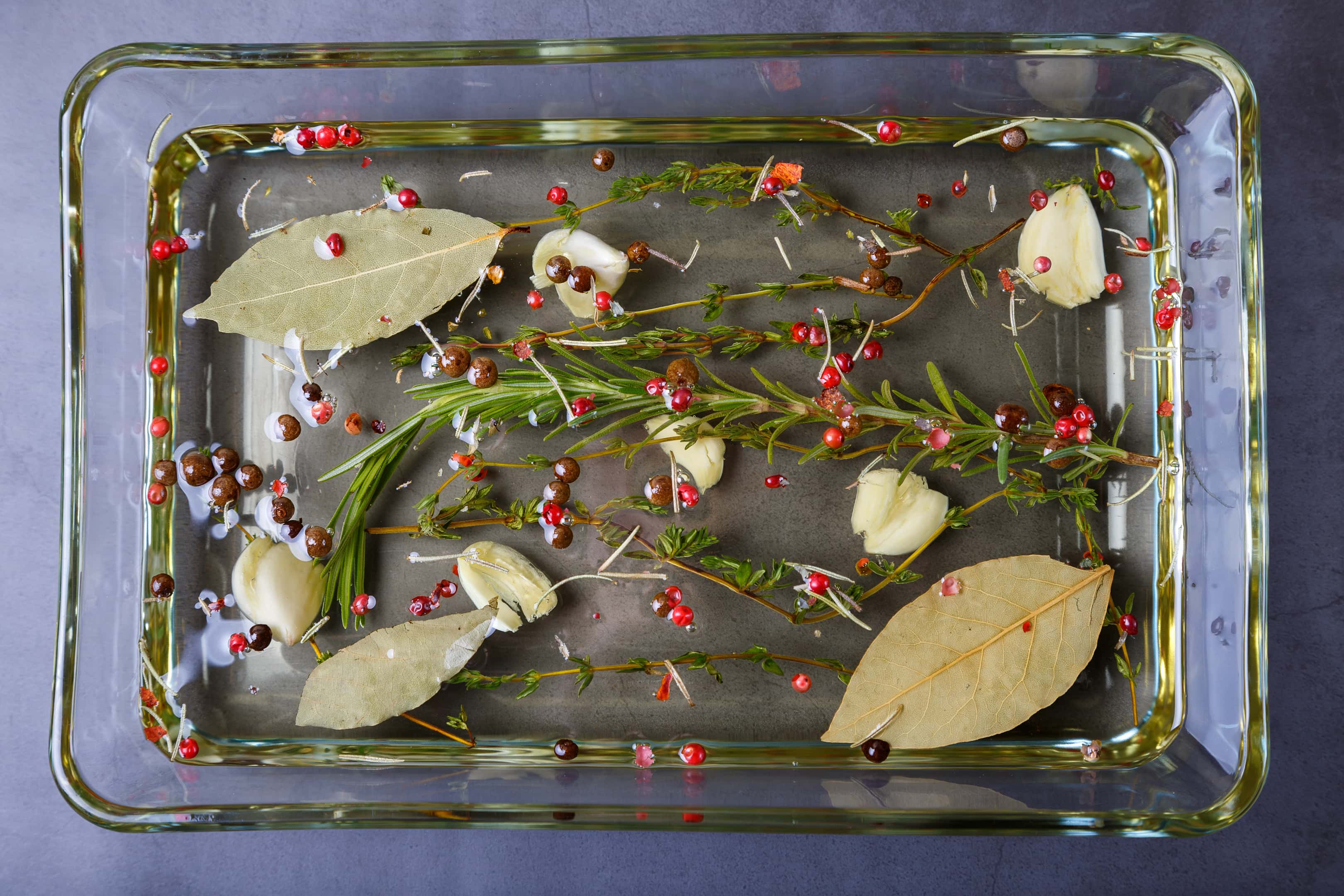 Olive oil with bay leaves, herbs and spices