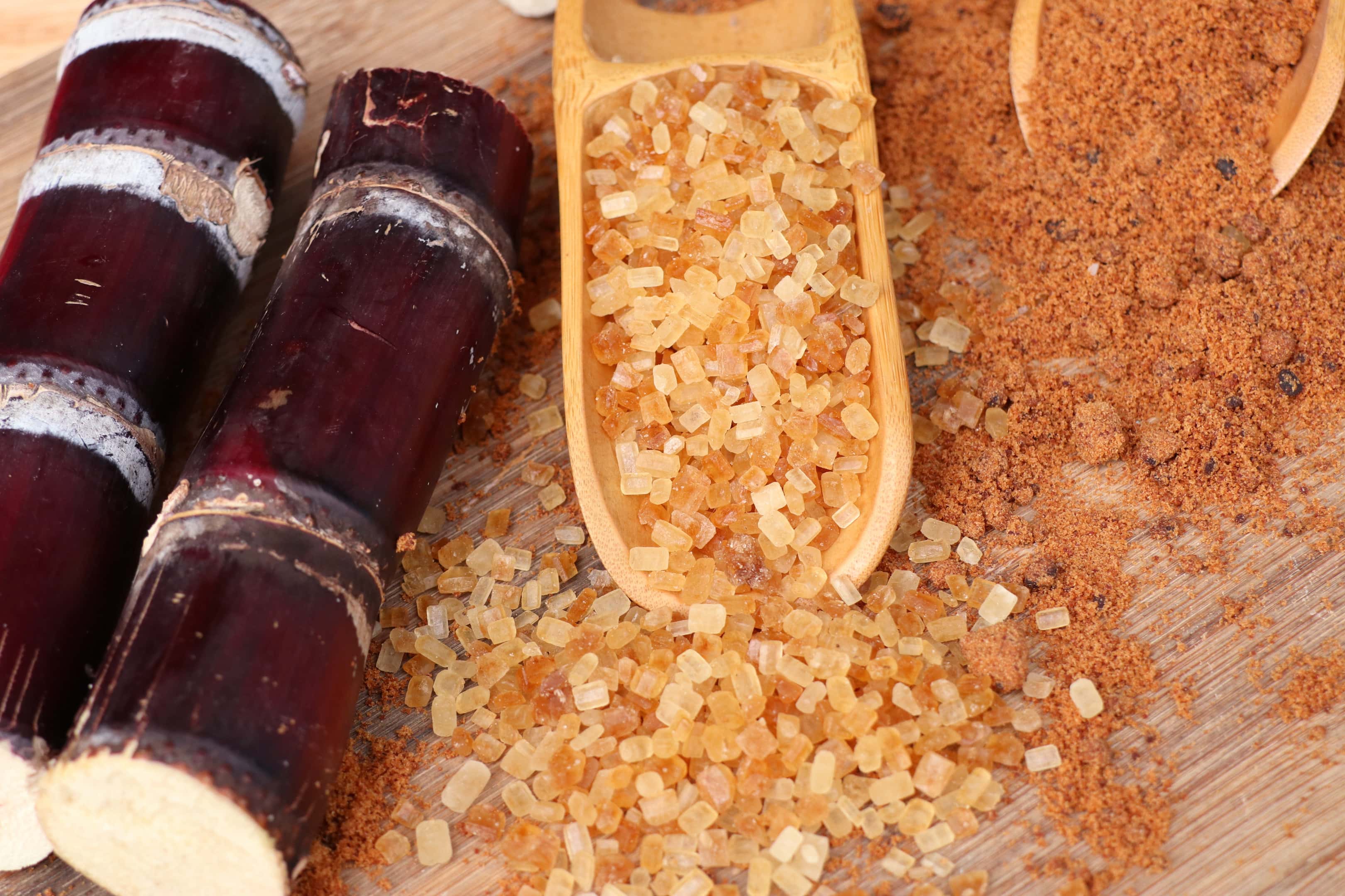 Organic sugarcane with molasses on wooden table