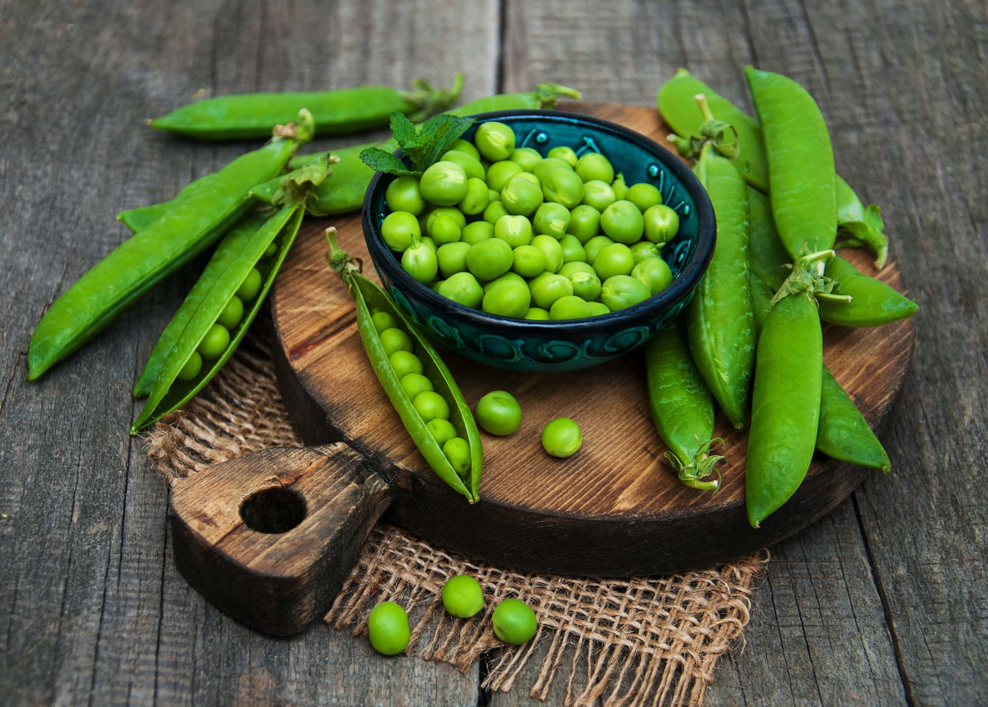Fresh peas on a wooden board