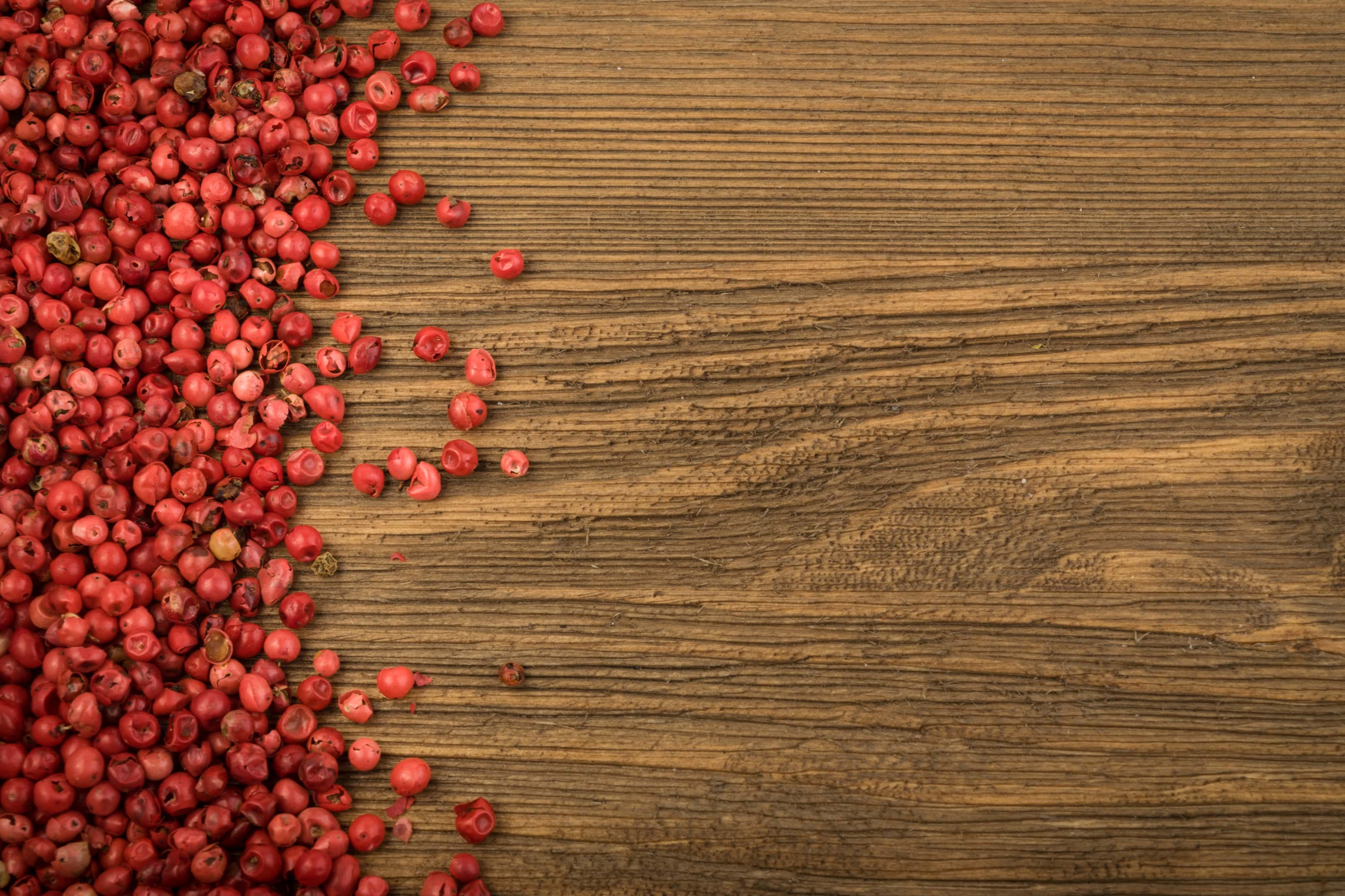 Pink peppercorn on wooden table