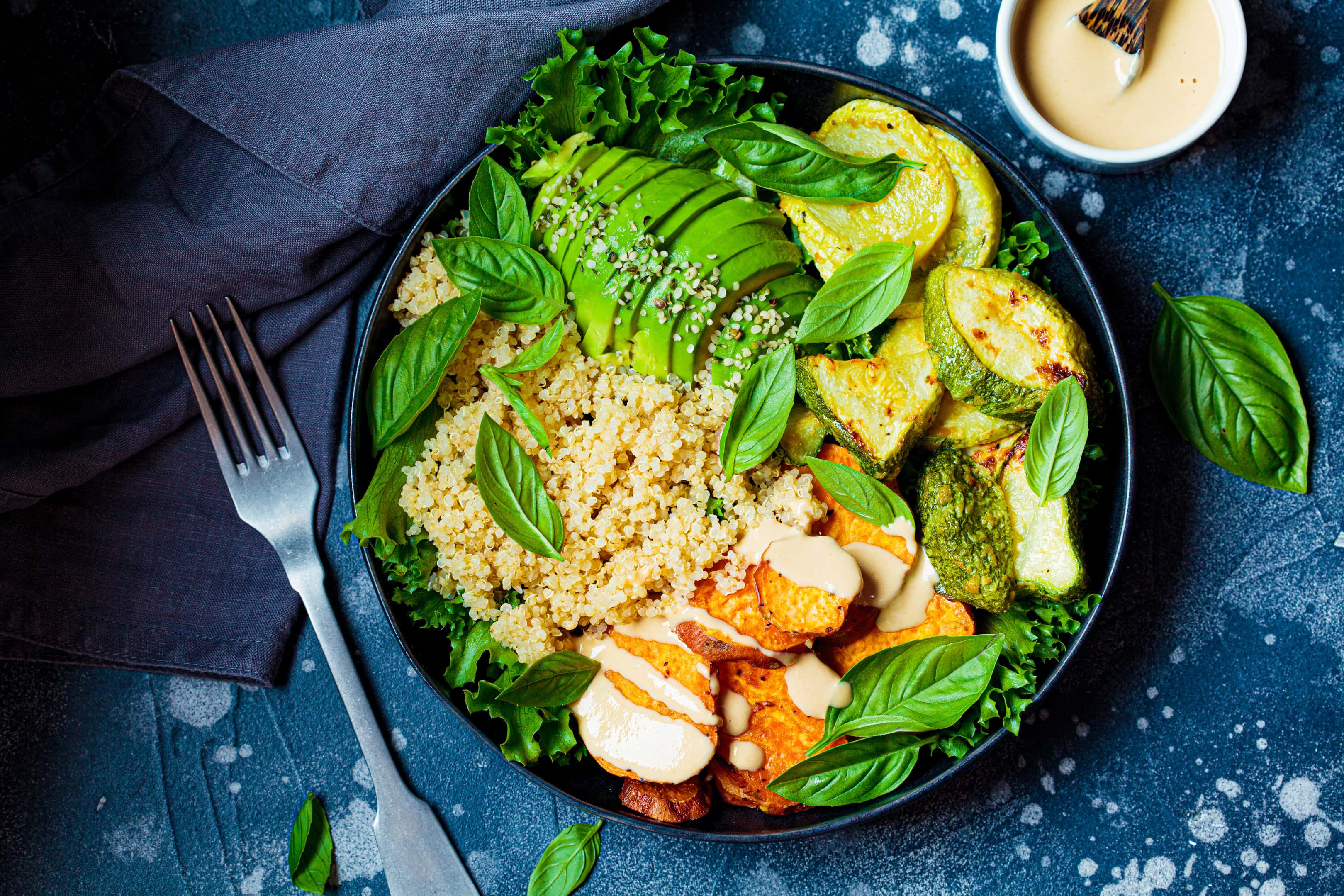 Quinoa salad with baked zucchini, sweet potato, avocado, tahini and lemon juice