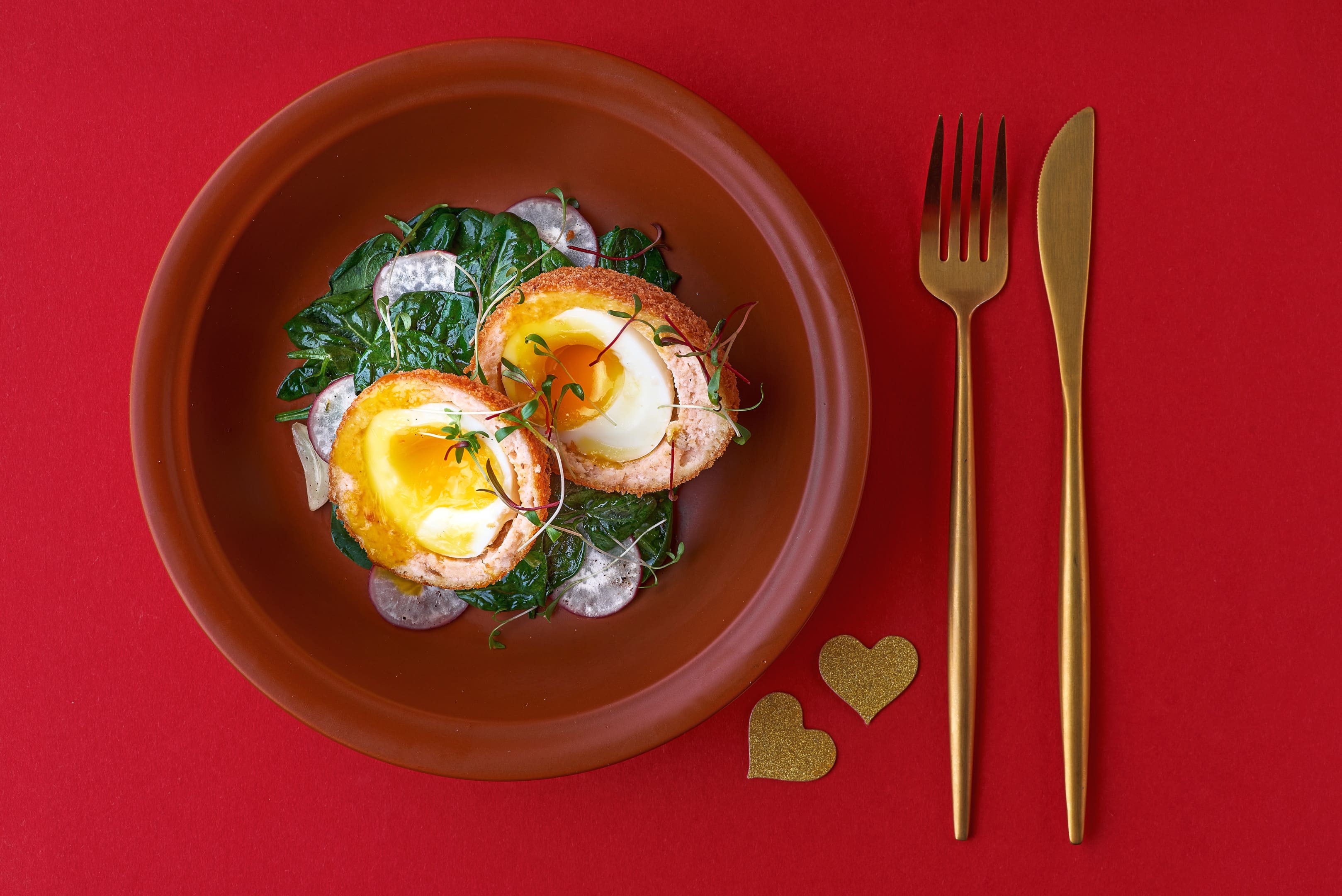 Scotch eggs with salmon, radish and spinach