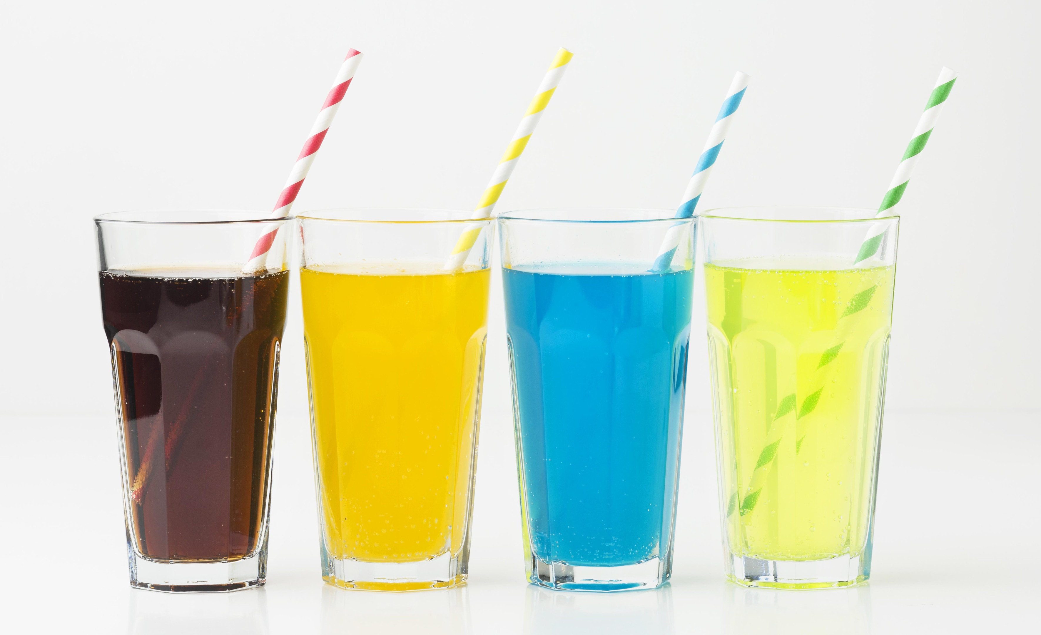 Glasses of carbonated soft drinks with straws