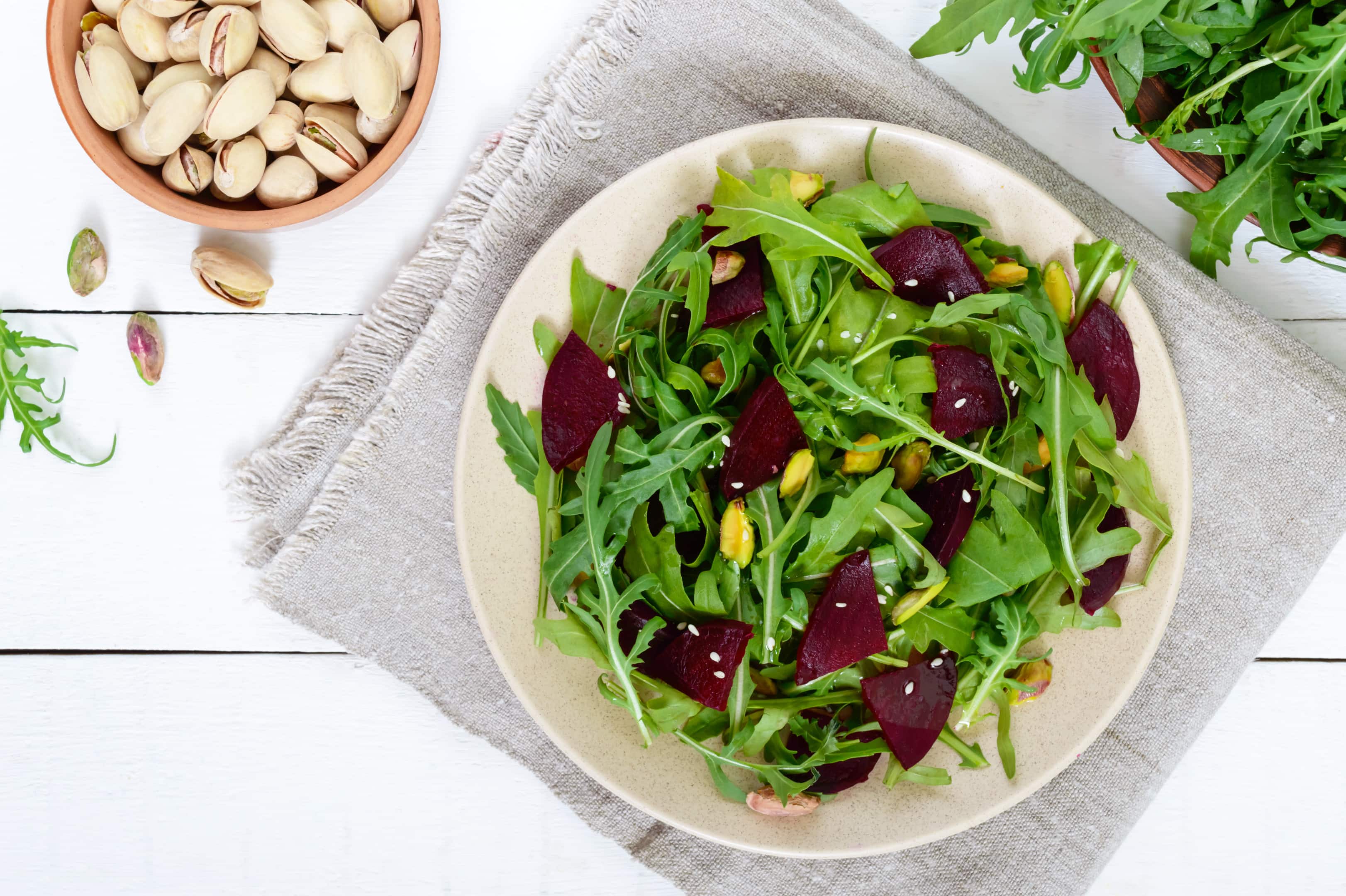 Spicy vegan salad of beets, arugula, pistachios and pistachio oil
