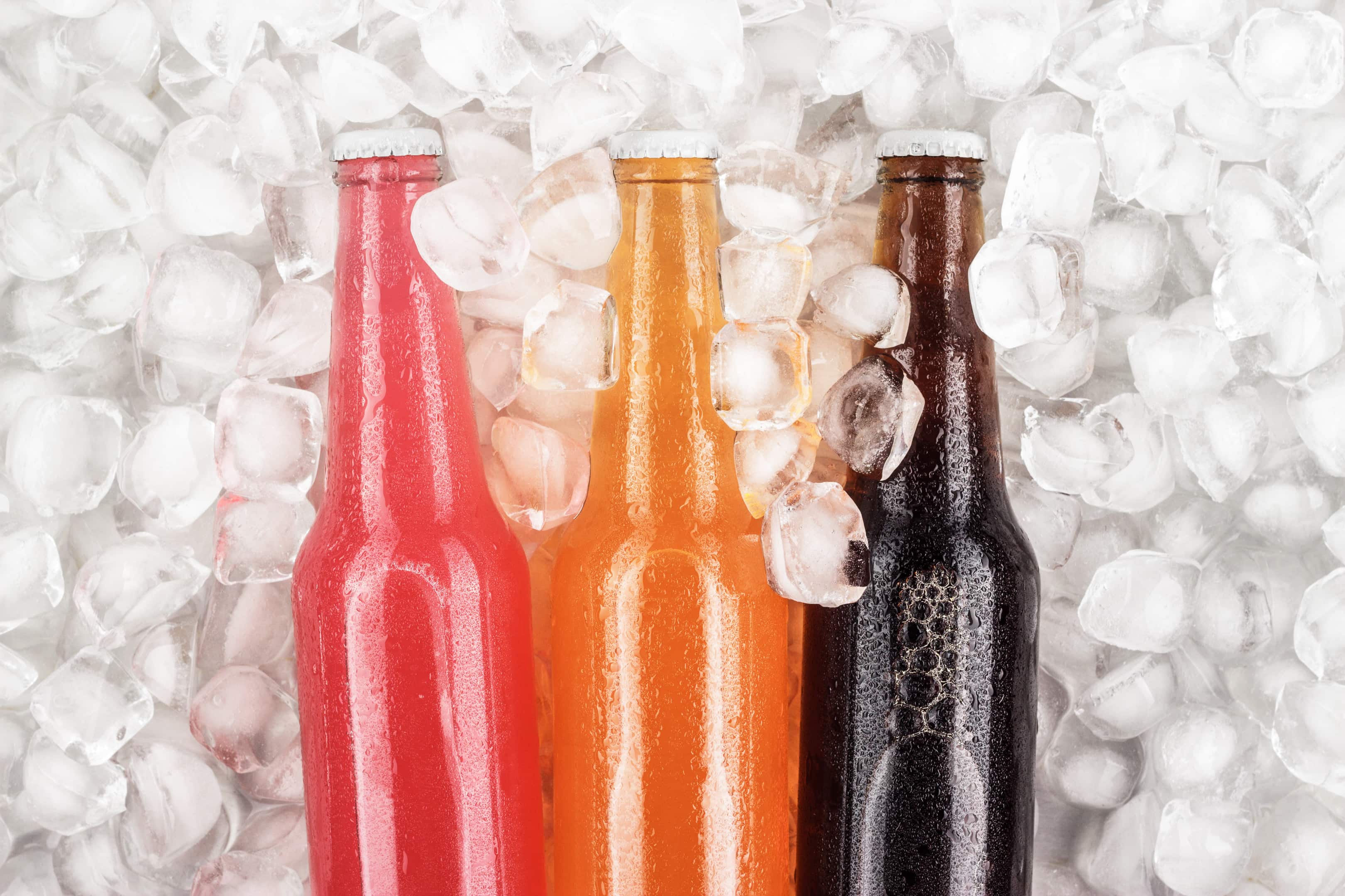 Sugar drinks in glass bottles over ice