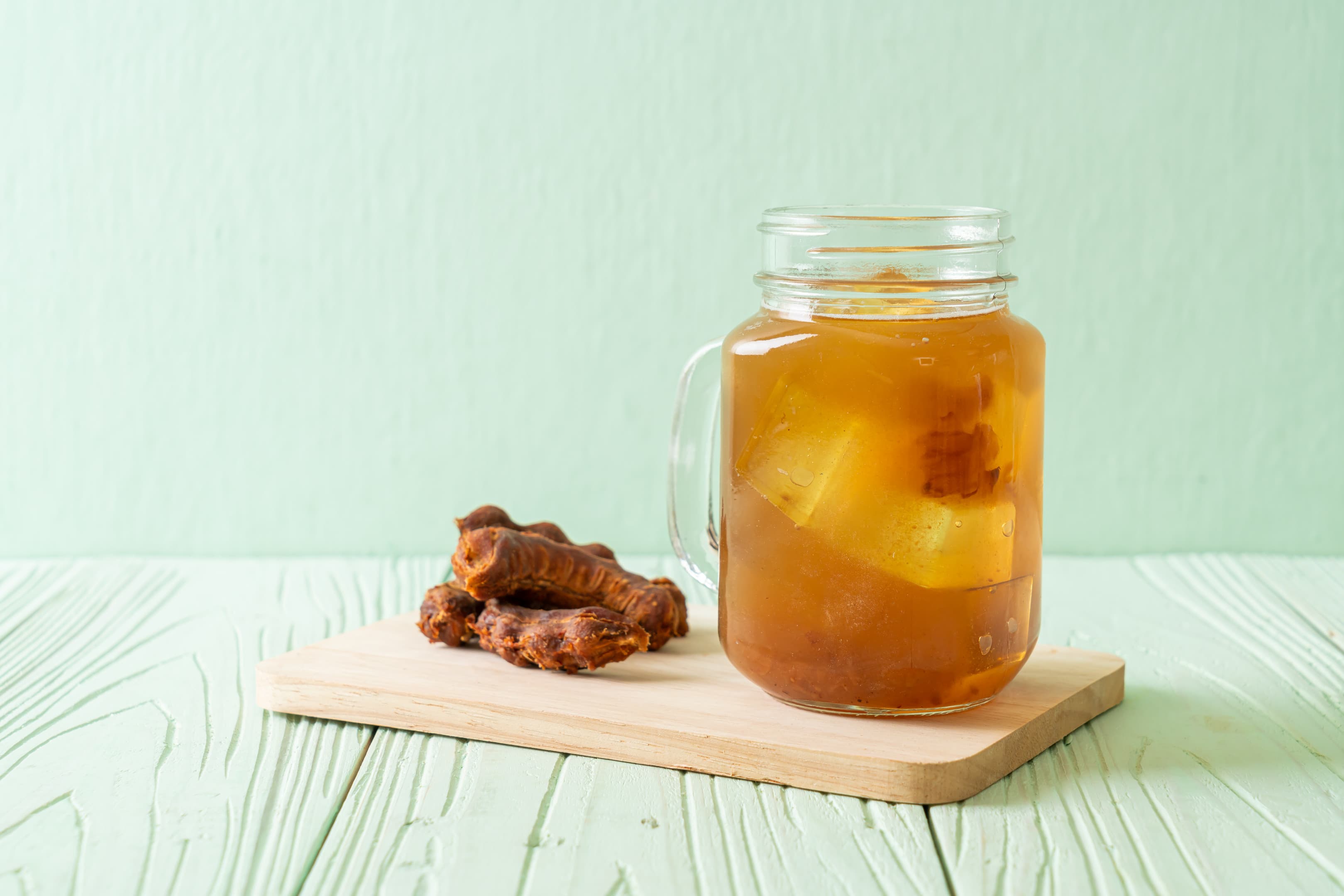 Sweet tamarind and turmeric juice with ice cubes