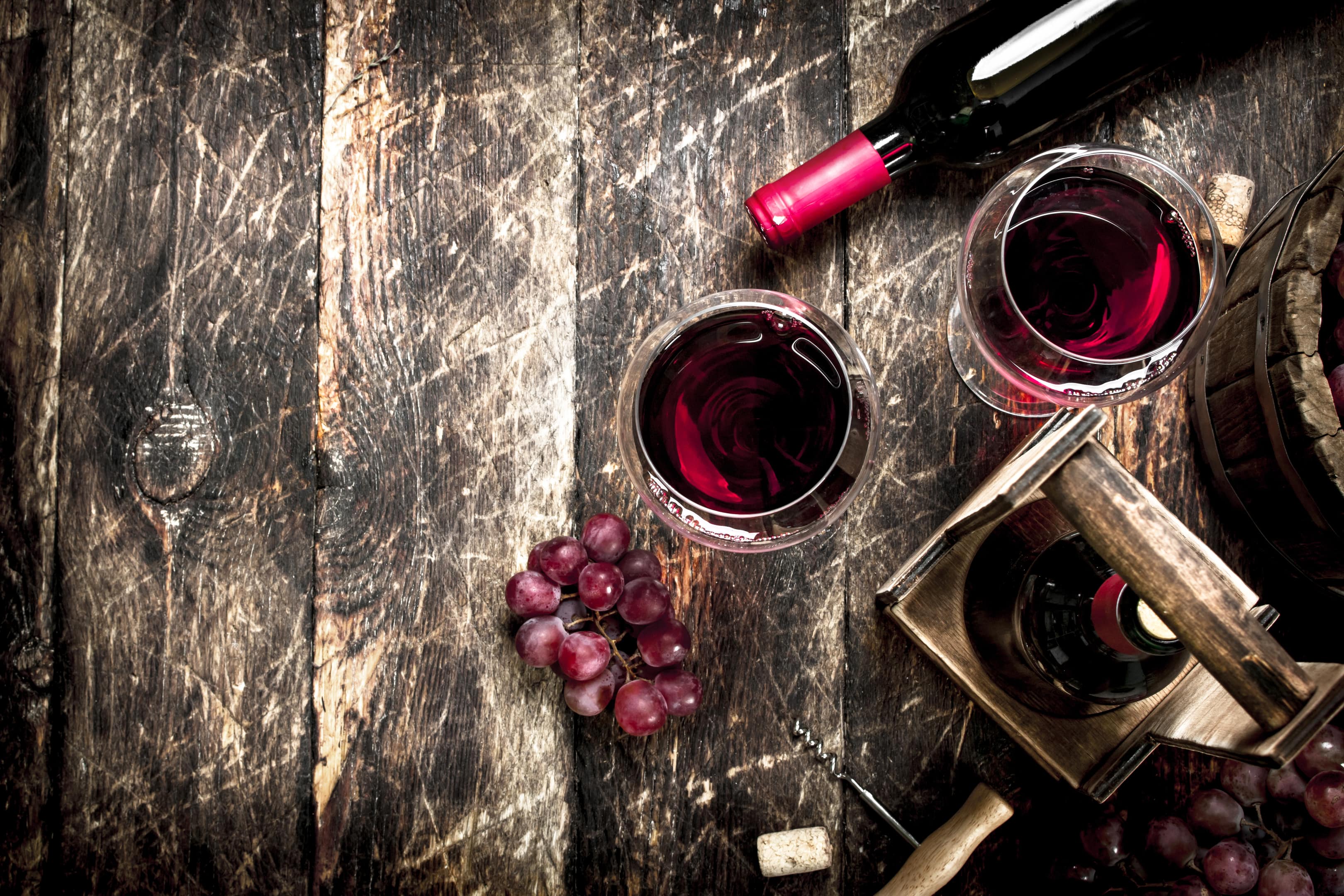 Red wine with glasses with grapes