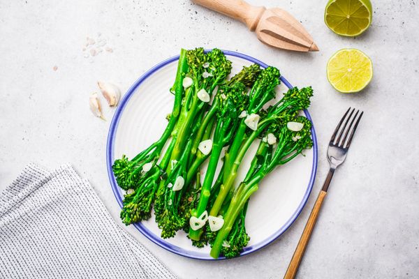 Boiled broccolini with garlic in a white plate