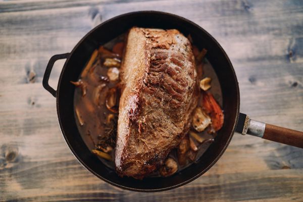Pan-roasted beef in a skillet with vegetables