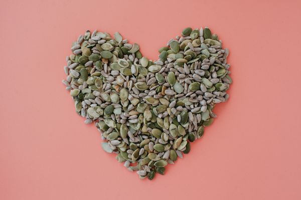 Sunflower and pumpkin seeds in heart shape