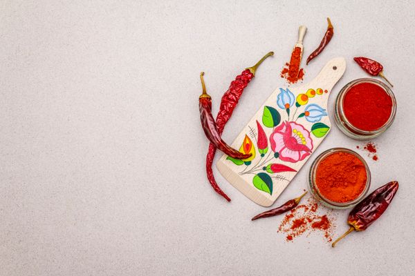 Achiote powder and blocks on wooden board