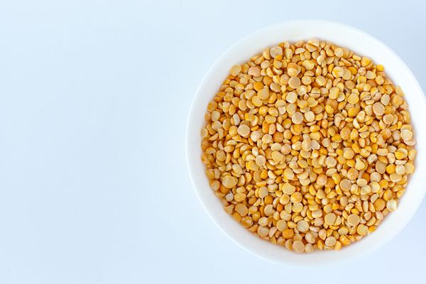 Yellow split peas in a white bowl