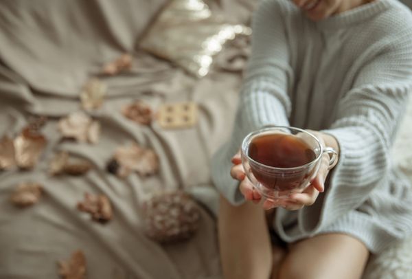 A woman holding a warm cup of tea.