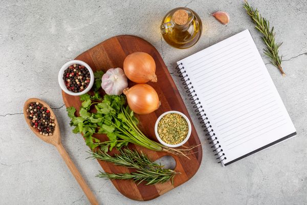Cookbook notebook with herbs and ingredients