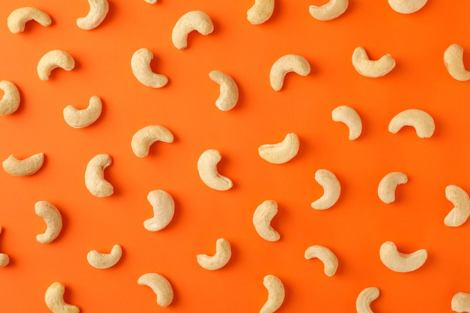 Cashew nuts on orange background
